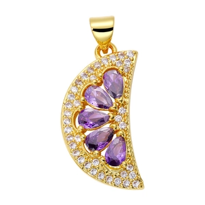Macro detail of crescent moon pendant with purple teardrop gems and white crystals