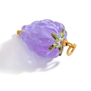 Detailed macro view of purple fruit glass pendant with 18k gold stainless steel clasp