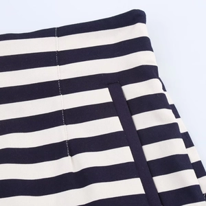 Detail view of high waist shorts showing navy blue and white stripes with side pocket seam