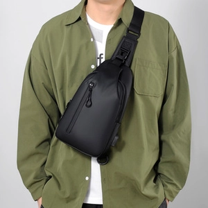 Detail of waterproof black crossbody chest bag with integrated USB charging port