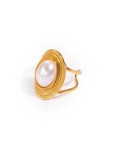 Detailed macro of vintage gold cocktail ring with large oval pearl and beaded metal edges