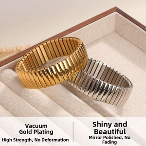 Detail view of gold and silver elastic stainless steel bracelets with polished finish