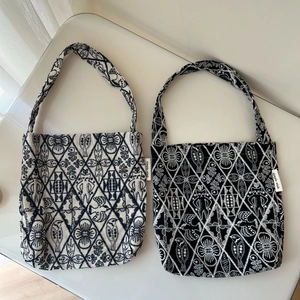 Close-up of geometric bird and floral embroidery on premium cotton canvas tote bags