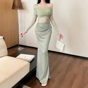 Detail of elegant light green mesh top and high-waisted satin maxi skirt set