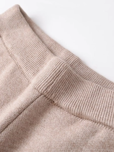 Close-up of oatmeal knit fabric showing detailed ribbed texture and quality stitching