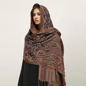 Detail shot of navy blue paisley cashmere-like shawl with intricate patterns and fringe