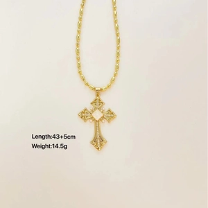 Vintage gold cross necklace with pearls and crystals on a white background