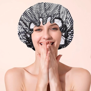 Close-up of a black and white checkered waterproof shower cap with black ruffled elastic edge