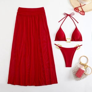 Three-piece red bikini set with gold ring hardware and matching sheer mesh maxi skirt