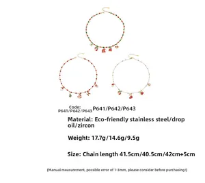 Detailed view of Christmas pendants featuring enamel trees and snowmen on steel chains