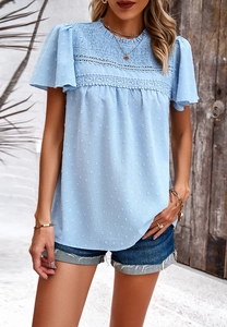 Detail of light blue short sleeve blouse with lace trim and smocked texture design