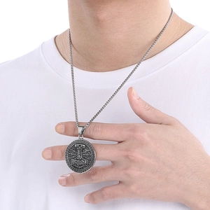 Detail of a vintage Viking Thor's hammer pendant on a model in silver stainless steel