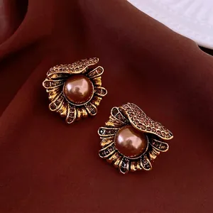 Vintage shell-shaped gold earrings with brown faux pearls and rhinestones on silk