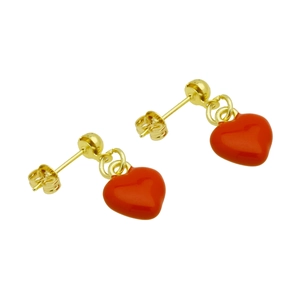 Detail of gold-plated hoop earrings featuring polished red enamel heart-shaped pendants
