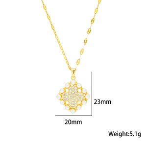 Golden clover necklace with white pearls and sparkling crystals on a clean white background