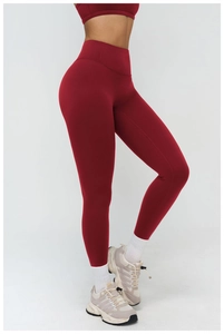 Close-up of deep red high-waisted yoga pants with lift effect and compression fit