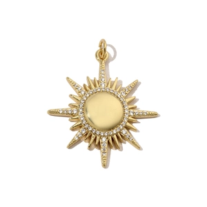 Macro shot of sunburst pendant in gold finish with sparkling cubic zirconia inlay