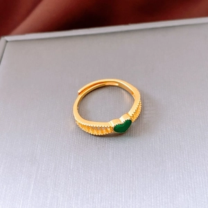 Detail of vintage French open ring with green heart inlay and hollow woven texture