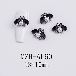 Detail of silver insect nail charms with black gems and white pearls for Halloween