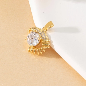 Detail view of golden evil eye pendant featuring large zircon stone and pavé accents