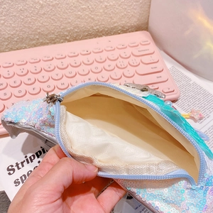 Detail view of the shimmering sequin bag interior with soft cream fabric lining