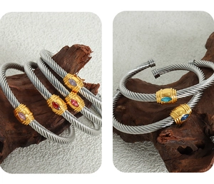 Detailed macro of twisted cable stainless steel cuff featuring colorful marquise stones