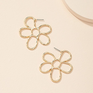 Detailed view of hollow gold flower earrings with a minimalist six-petal metal design