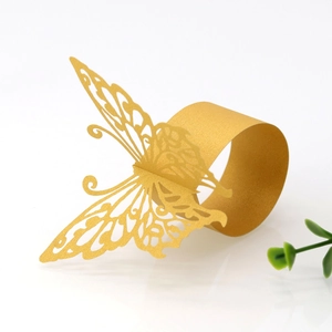 Detailed view of hollow golden butterfly paper napkin ring with metallic luster