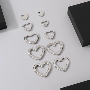 Various sizes of stainless steel heart pendants including hollow and crystal designs