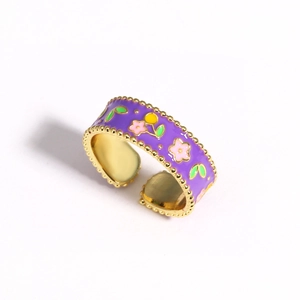 Detail view of purple enamel flower ring with golden beaded edges and adjustable band