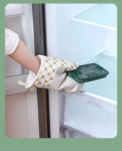 Close-up of white floral oven mitt taking a frozen ice tray from the freezer