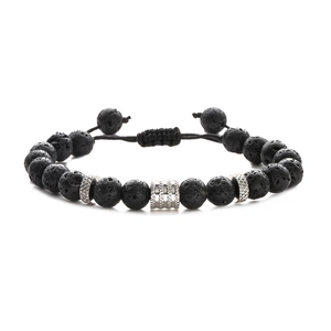 Detail of adjustable braided cord bracelet with black lava rock beads and steel accents
