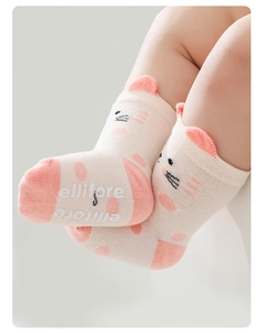 Detail of baby socks with anti-slip ellitore print and cute 3D cat ear design