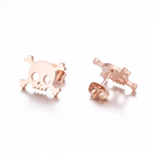 Detail of rose gold skull stud earrings with hollow design and butterfly backings