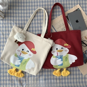 Detail of cute duck canvas tote bag with 3D plush feet and cartoon print on blue pattern