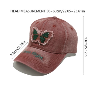 Detail of red washed denim baseball cap with butterfly patch and Free flight embroidery