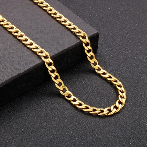 Close-up of golden stainless steel Cuban link chain necklace on a black jewelry box