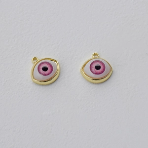 Detailed view of pink eye-shaped jewelry pendants with gold alloy frames for DIY crafts