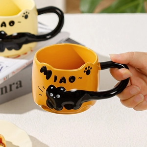 Cute ceramic mug with 3D black cat relief handle in yellow and orange colors