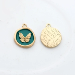 Detailed macro view of enamel butterfly pendant showing embossed front and textured back