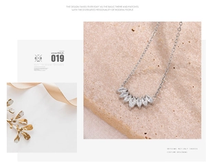 Detail of fan-shaped marquise-cut zircon pendant on a silver-plated necklace chain
