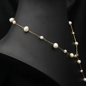 Elegant 18K gold long sweater chain with baroque freshwater pearls on black neck model