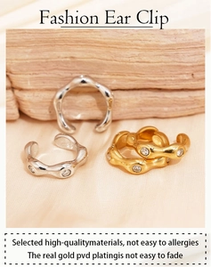 Close-up of gold and silver irregular zircon ear clips with PVD plating details