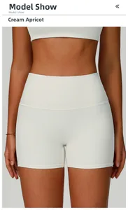 Detail view of high-waist ribbed yoga shorts in creamy apricot on a fitness model