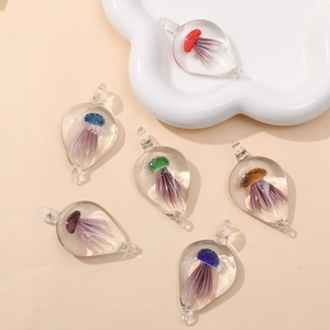 Handcrafted teardrop glass pendants with colorful jellyfish motifs in diverse vibrant colors