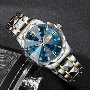 Detail of blue dial men's quartz watch with diamond markers and two-tone metal strap