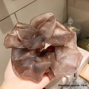 Detail view of champagne gold organza scrunchie with shiny glitter and 14cm diameter
