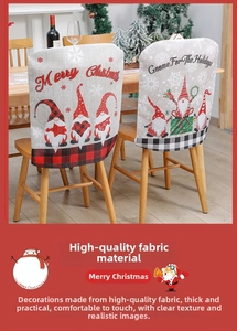 Detail of linen Christmas chair cover with cute gnome pattern and Merry Christmas text