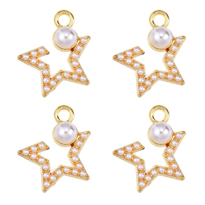 Detailed view of four gold star pendants with white pearls for DIY jewelry making