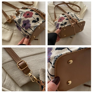 Close-up of floral jacquard bucket bag with brown faux leather trim and gold hardware details